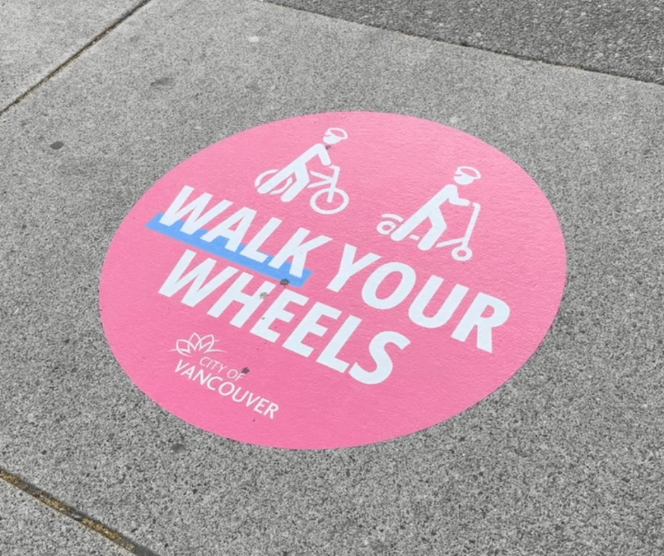 'Walk your wheels' sticker on a road